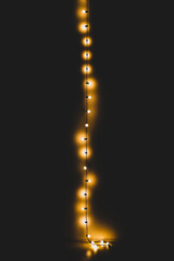 vertical string of lights in the dark