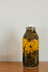 A Jar of Oil Infused with Plants and Herbs