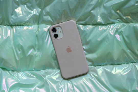 Ukraine Dnepr 13.01.2022 - iphone 12s mini lies on a soft puffy light jacket, new phone, new iPhone 12