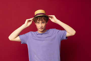 teenager in Hat purple t-shirts posing emotions red background unaltered
