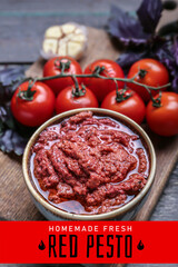 Bowl of tasty red pesto sauce and ingredients on table