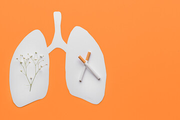 Paper human lungs with flowers and cigarettes on color background