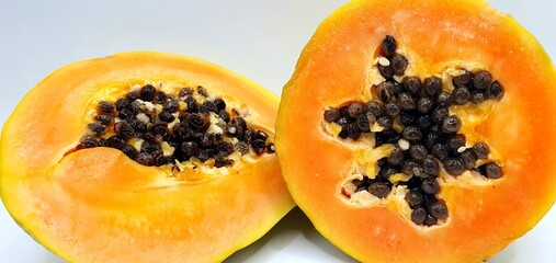 Sweet papaya on a white background. Ripe juicy papaya pulp with seeds. Exotic tasty papaya fruit. Fruit background.