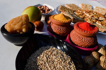 Makar sankranti traditions with kumkum haldi, jaggery,  ber fruit chikki sesameseeds 