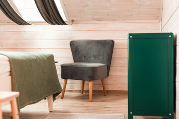 Bed with green commode and armchair on light wooden home background. Background wall design. Vintage, retro design