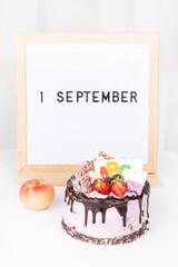 Beginning of the school year concept, festive cake with ABC, apple
