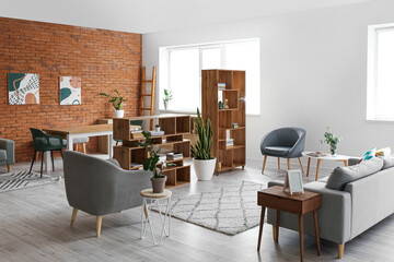 Interior of light living room with stylish bookshelves