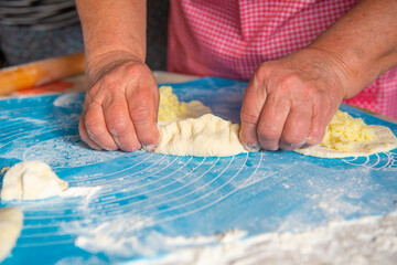 mom makes a lot of pies out of dough. High quality photo