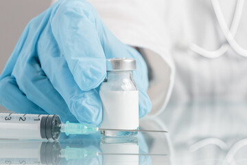 Fototapeta premium Scientist or medical worker holds vaccine bottle.Vaccination, immunization, treatment to provides active acquired immunity to a particular infectious disease. Healthcare And Medical concept.