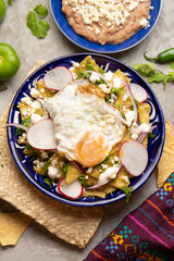 Mexican green chilaquiles with fried egg and cheese