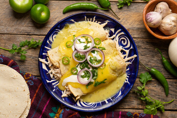 Mexican green enchiladas with chicken and melted cheese