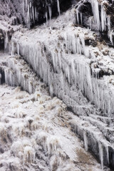 Beautiful frozen waterfall. Close-up of ice crystals. Icicles hanging from rocks. Waterfall Chirkhalyu or Chvakhilo on the river Oysor in Dagestan, Russia