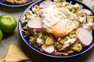 Mexican green chilaquiles with fried egg and cheese