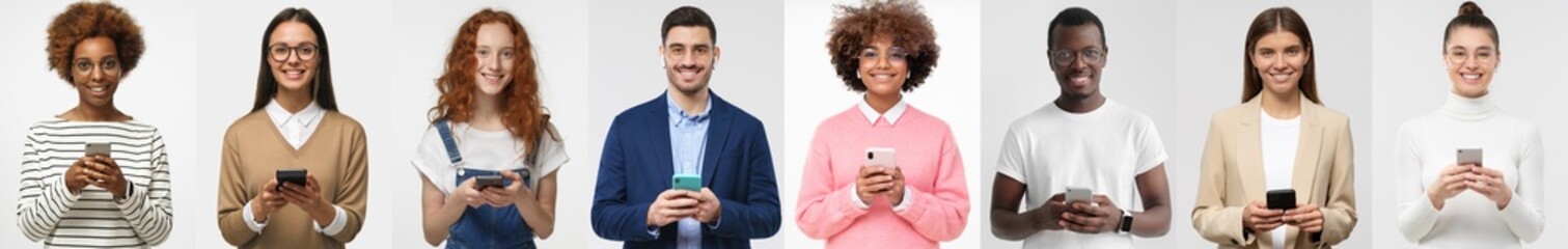 Group portrait of smiling multiethnic young people holding their phones