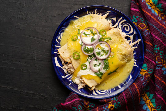 Mexican green enchiladas with chicken and melted cheese