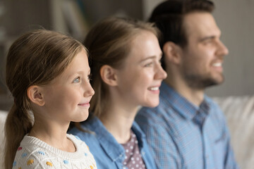 Profile side view focus on adorable little preteen kid daughter looking in distance with caring...