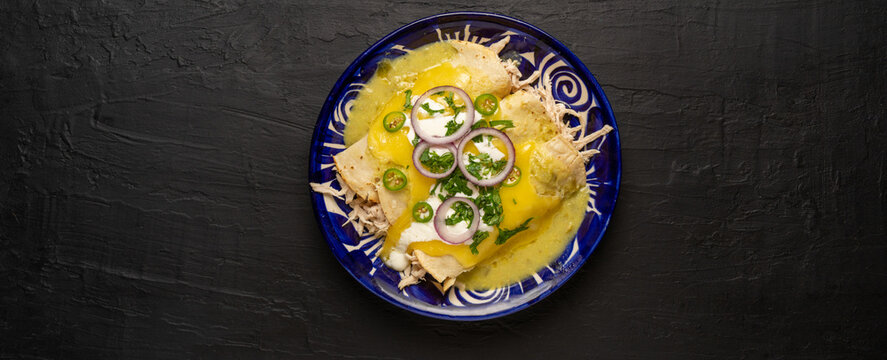 Mexican green enchiladas with chicken and melted cheese