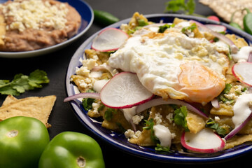 Mexican green chilaquiles with fried egg and cheese