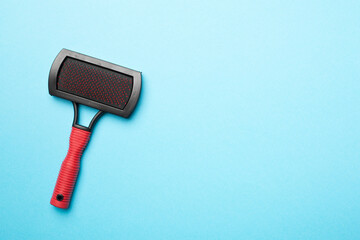 Pet brush on wooden background