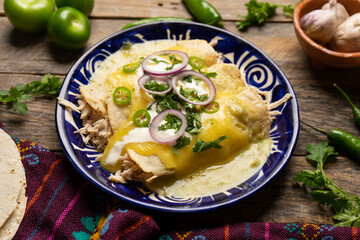 Mexican green enchiladas with chicken and melted cheese