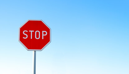 STOP - Czerwony znak stop na niebieskim tle, zatrzymać się , symbol, sprzeciw - obrazy, fototapety, plakaty