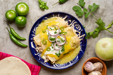 Mexican green enchiladas with chicken and melted cheese