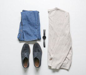 Stylish male clothes, shoes and smartwatch on light background
