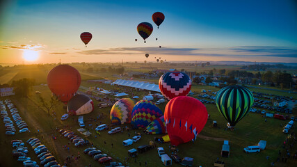 Aerial View of Many Hot Air Balloons Getting Ready to Take Off On An Early Morning Balloon Festival © Greg Kelton