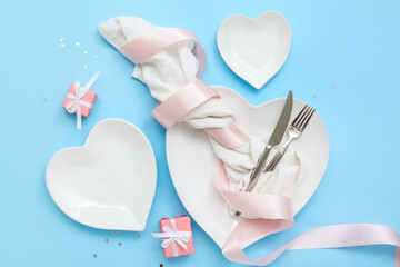 Beautiful table setting for Valentine's Day on blue background