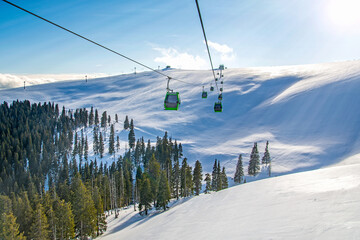 Carpathians mountains in winter in Romania, Transalpina ski resort, gondola over valley 