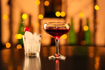Glass of tasty Manhattan cocktail on table in bar