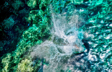 Child splashing in the sea water in Malta