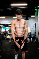 Fototapeta na wymiar handsome man doing chest training at gym. details of fitness trainer and athlete working out and exercising