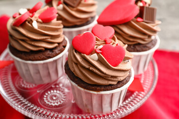 Stand with tasty chocolate cupcake for Valentine's Day on table, closeup