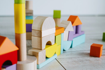 Colorful cubes made of natural material. Children's construction kit made of natural wood....