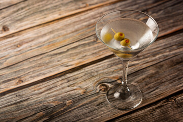 Dry martini drink with green olives.