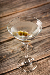 Dry martini drink with green olives.