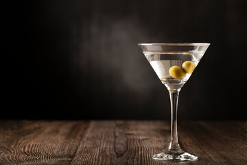 Dry martini drink with green olives.