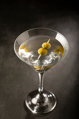 Dry martini drink with green olives.