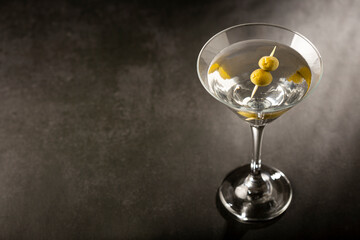 Dry martini drink with green olives.