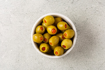 Stuffed green olives in a bowl.