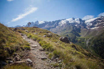 Summer panorama of the head of Vallelunga with Palla Bianca peak seen from a path with wooden crucifix, Alto Adige - Sudtirol, Italy. Popular mountain for climbers and travel destination