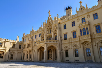 Fototapeta premium Lednice Castle in South Moravia in the Czech Republic. An important historical monument, the castle belonging to the Liechtensteins in the summer with a blue sky.