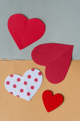 paper hearts on a partly torn background