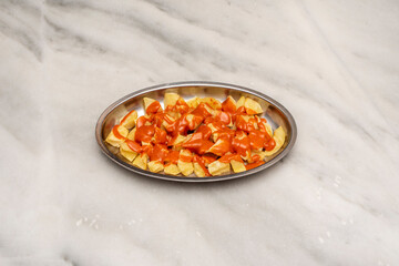 Fototapeta na wymiar Patatas bravas are typical tapas of Spanish bars that consist of potatoes cut into large cubes, fried in olive oil and seasoned with salsa brava, which is a spicy sauce.
