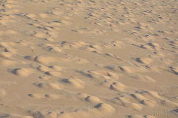Aerial view of sand dunes in Sahara desert in Tunisia, Africa. yellow sand dunes and dark shadows