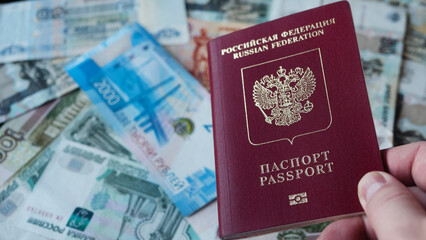 Russian passport on background with Russian rubles. - obrazy, fototapety, plakaty