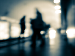 Blurry human silhouettes on the platform.