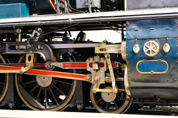 Obraz na płótnie Canvas Iron wheel drive mechanism system of a vintage locomotive train at The Bangkok Railway Station, Thailand 2