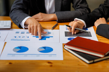 Business team present. Business man hands hold documents with financial statistic stock photo, discussion, and analysis report data the charts and graphs. Finance concept